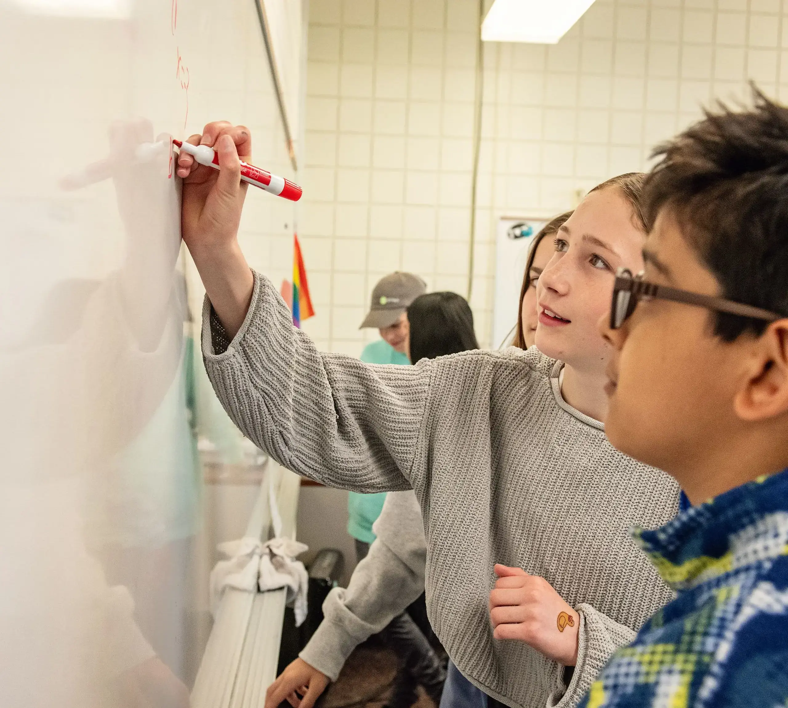 Students doing classwork on whiteboard