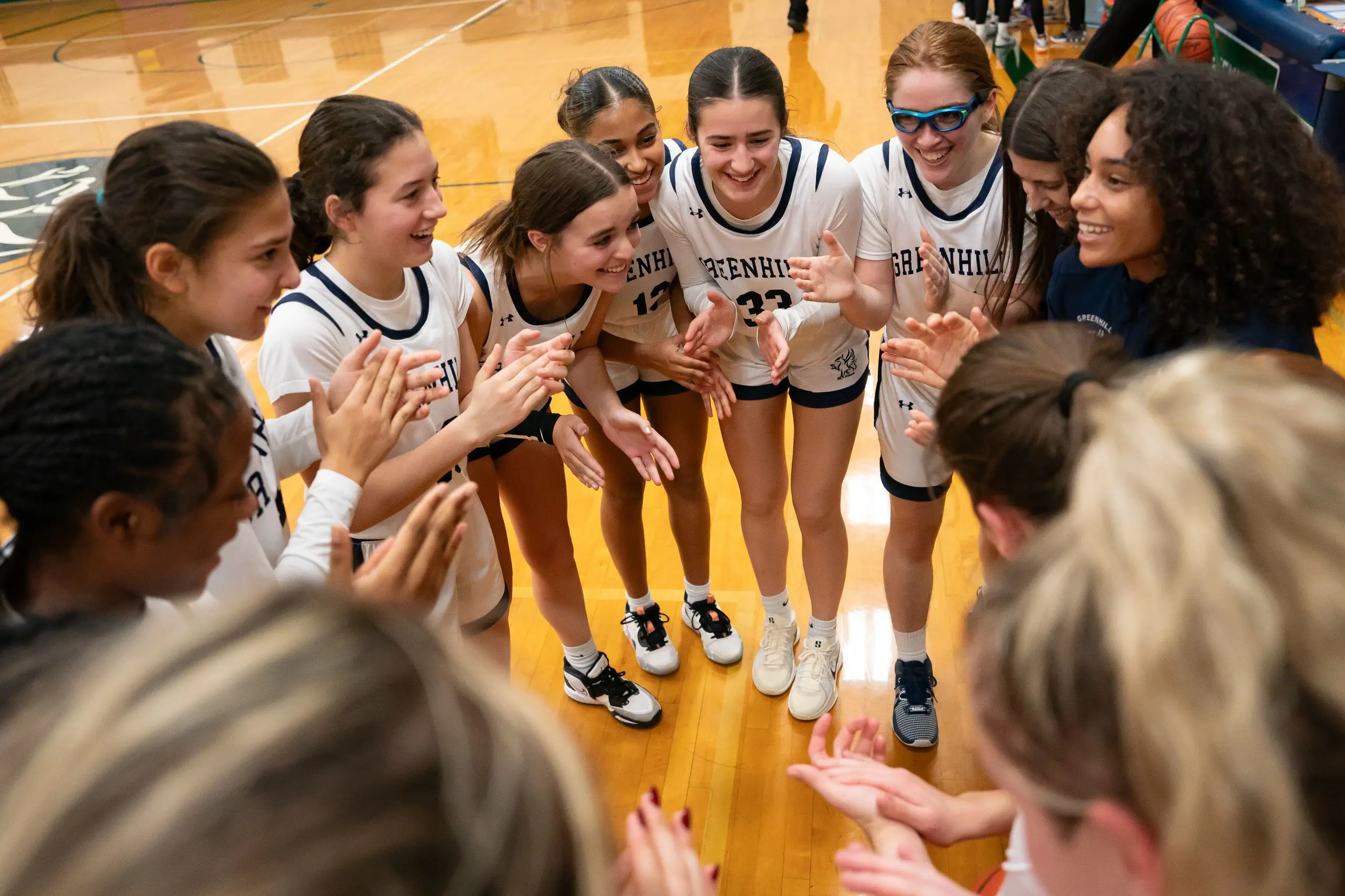 The girls basketball team comes together during a break