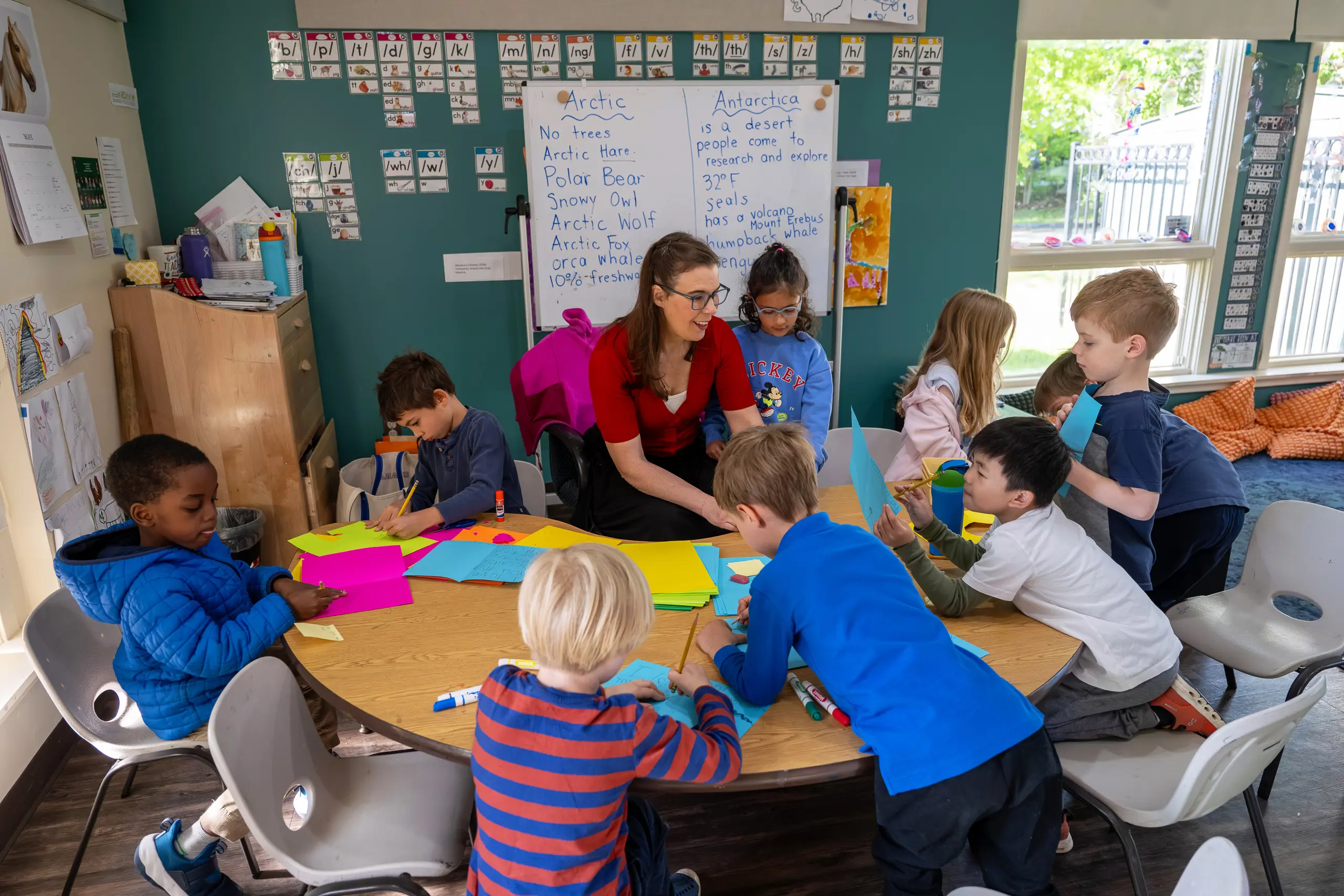 Lower school students at the table with their teacher
