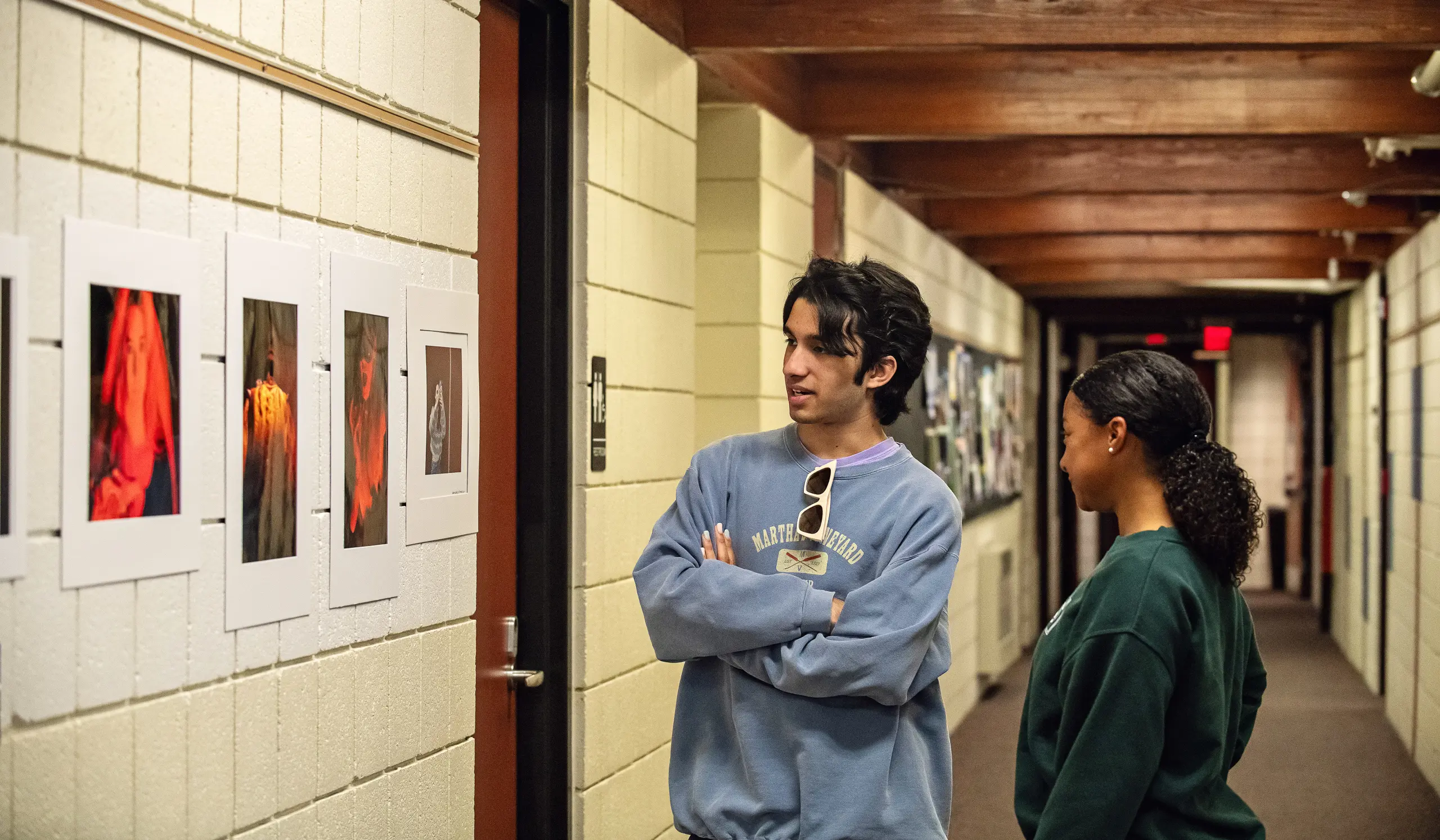 Students look at artwork on display in the halls of Greenhills