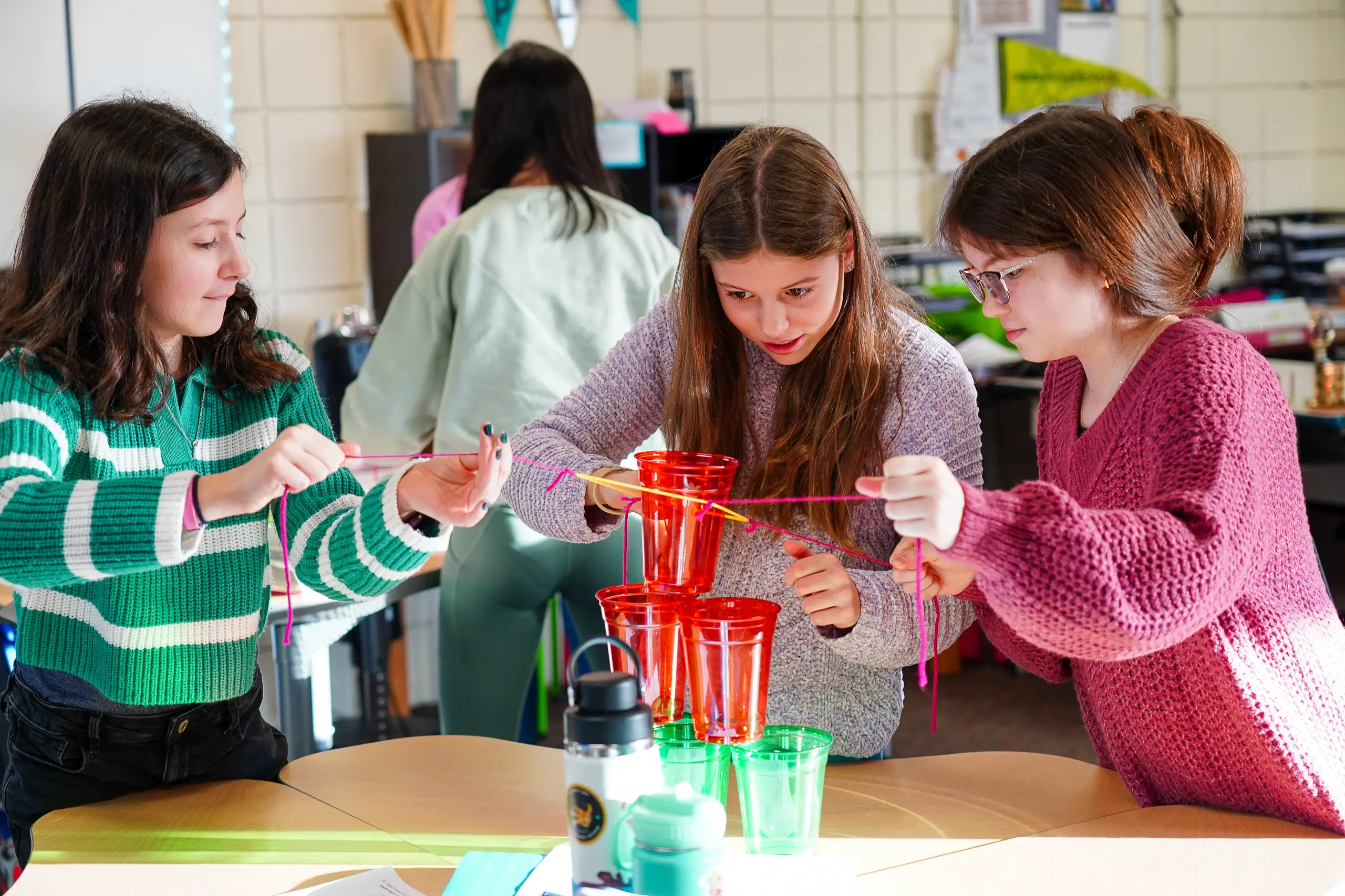 Middle school students working together to accomplish a task.