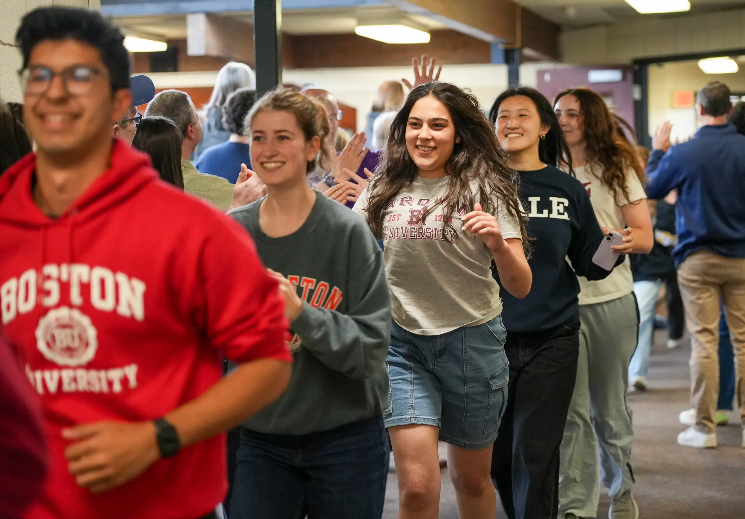 Seniors run through the halls while being celebrated by teachers and other students.